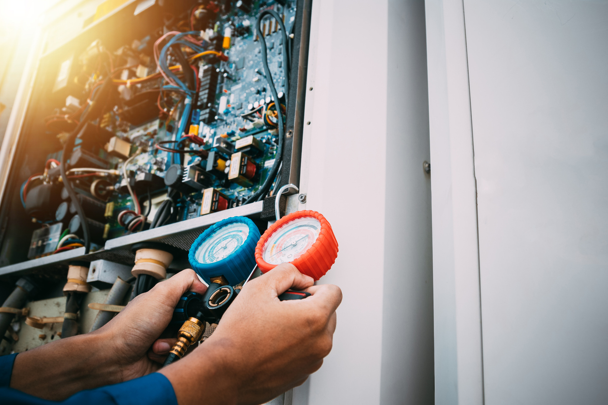 Technician is checking the air conditioner refrigerant leak.