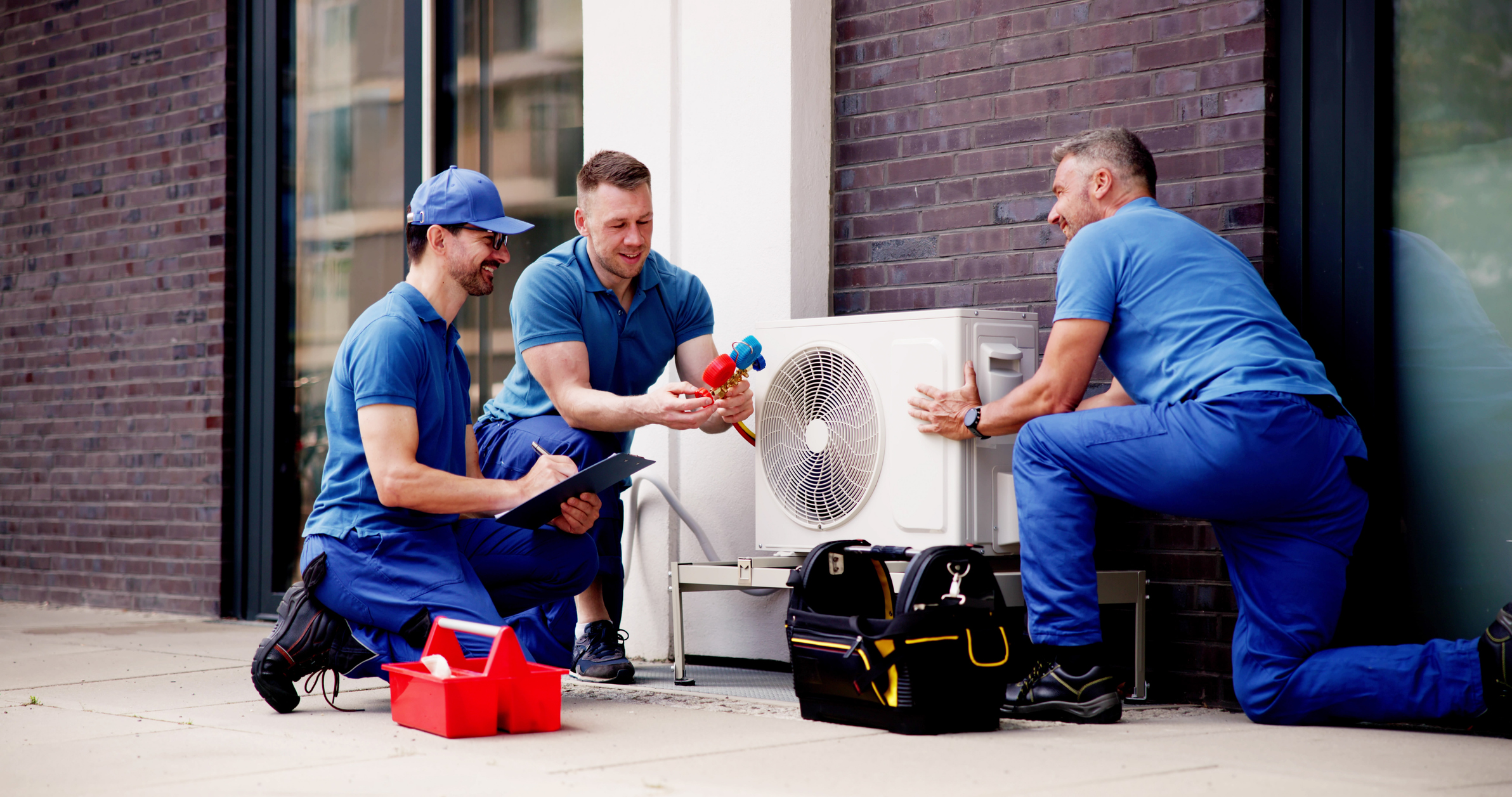 Servicemen offering Fredericksburg HVAC maintenance.